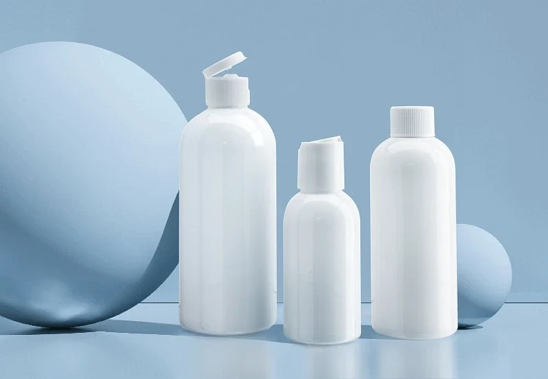 White cosmetic containers of various shapes on a light blue background